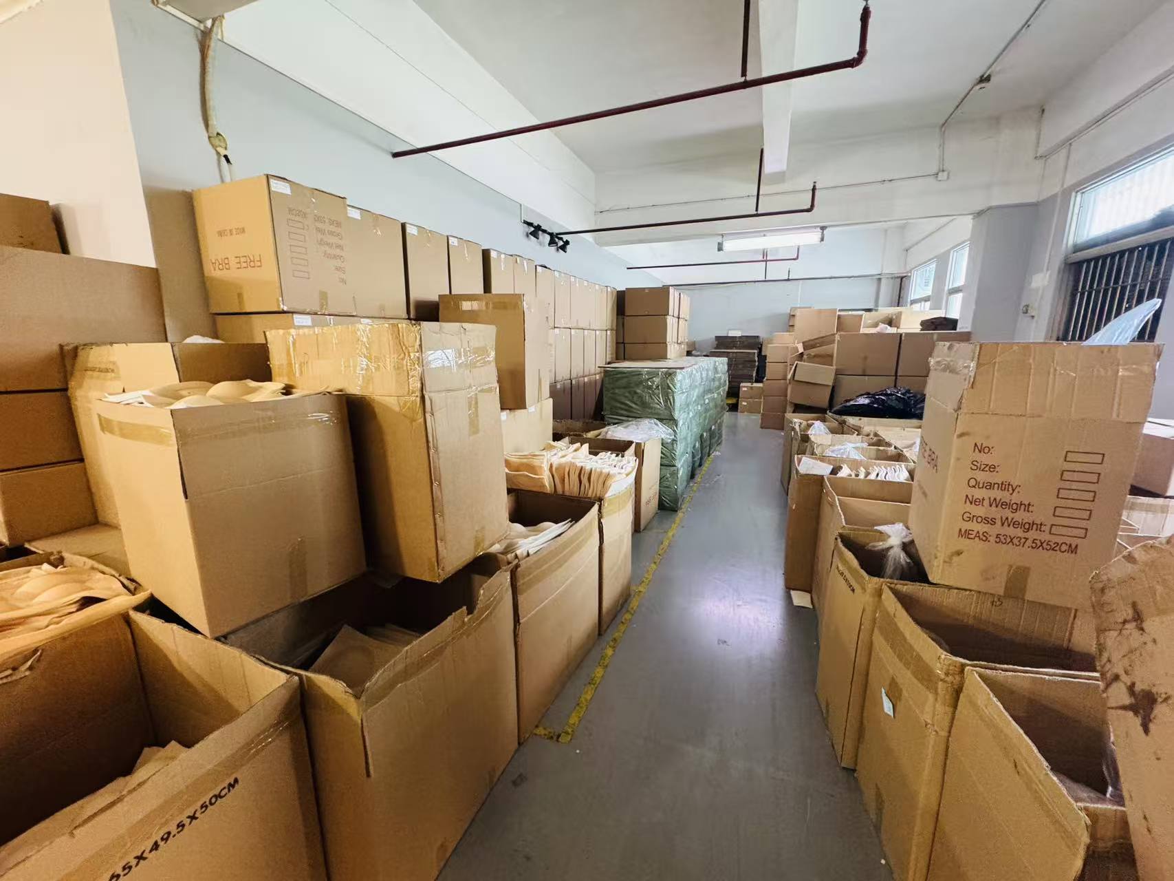 Factory warehouse with stock and cartons